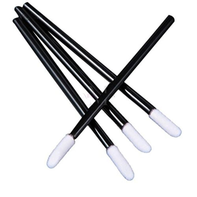 Crossed disposable micro applicators showing fine tips for precise eyelash extension work.