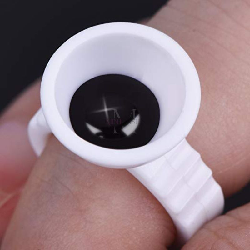 Close-up of a disposable plastic ring cup designed to hold pigment, glue, or liquid cosmetics.