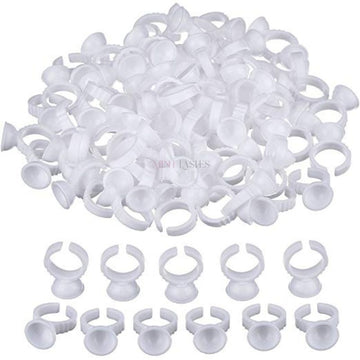 Bulk quantity of disposable plastic ring cups for professional beauty and cosmetic applications.