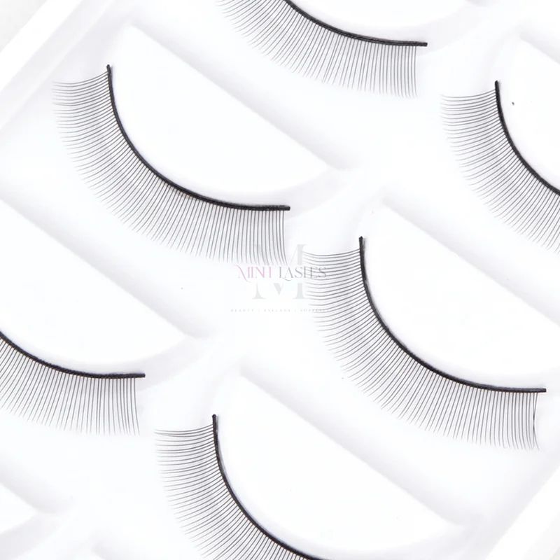 Close-up view of fine training eyelashes designed for realistic eyelash extension practice.