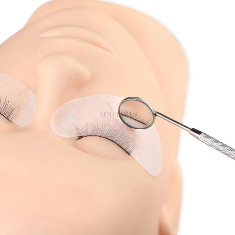 Eyelash inspection mirror used to check lash extensions during application.