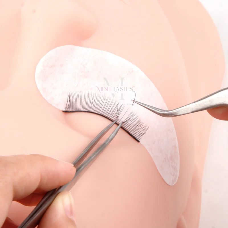 Training eyelashes applied on mannequin for eyelash extension practice and skill improvement.