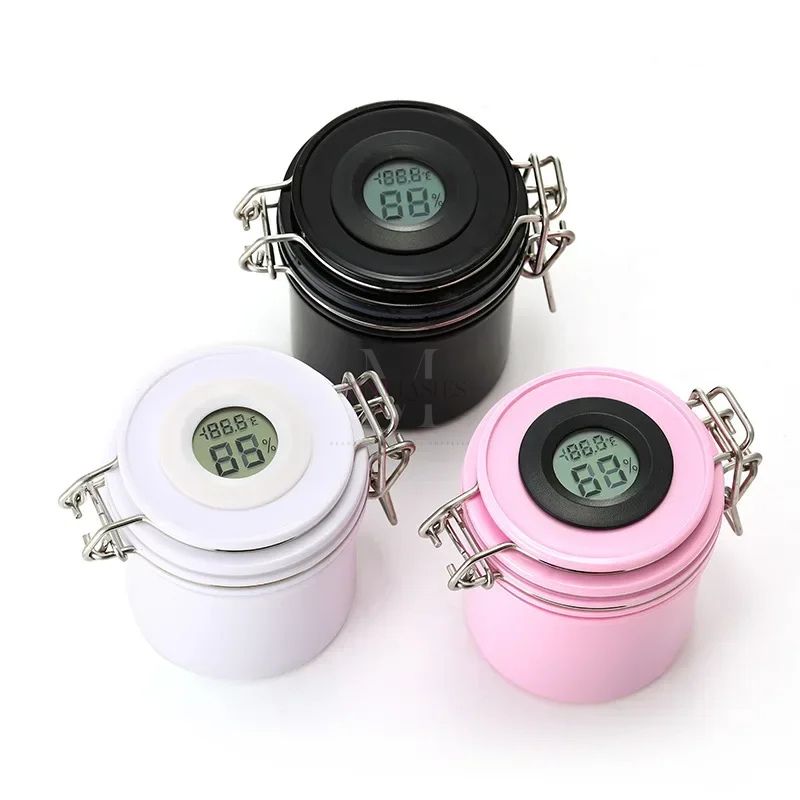 Lash glue storage tank with digital hygrometer in black, white and pink, designed to control humidity and protect eyelash adhesive.